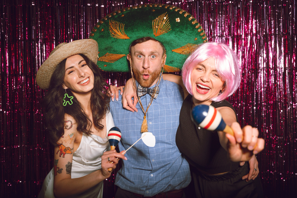 Photo booth New Orleans guests using fun props at party celebration