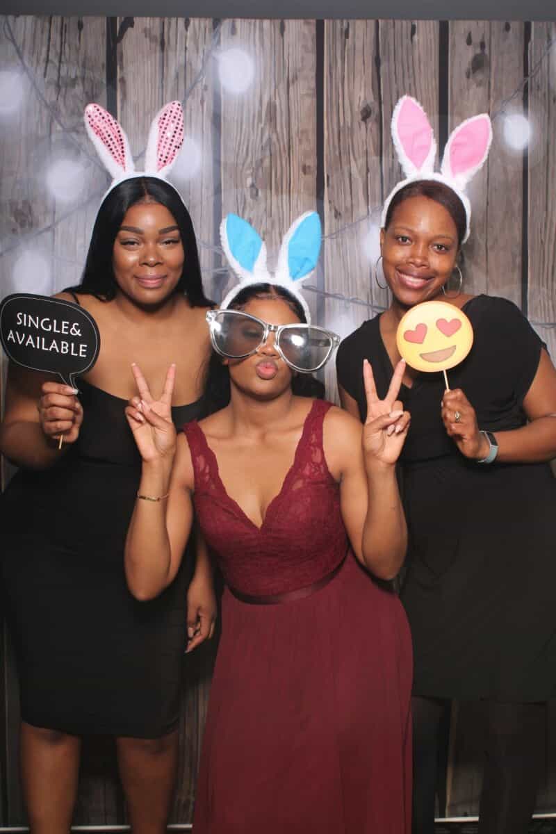Photo booth New Orleans group of guests posing with fun props and bunny ears